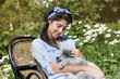 beautiful woman hugging her poodle dog in a summer garden