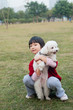 Asian kid holding dog